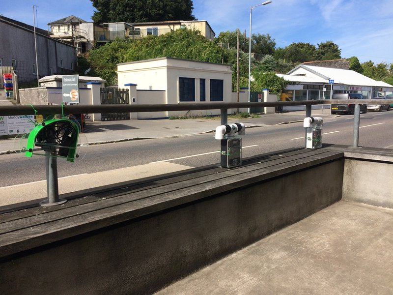 photo of 3 sensors on a railing alongside a road
