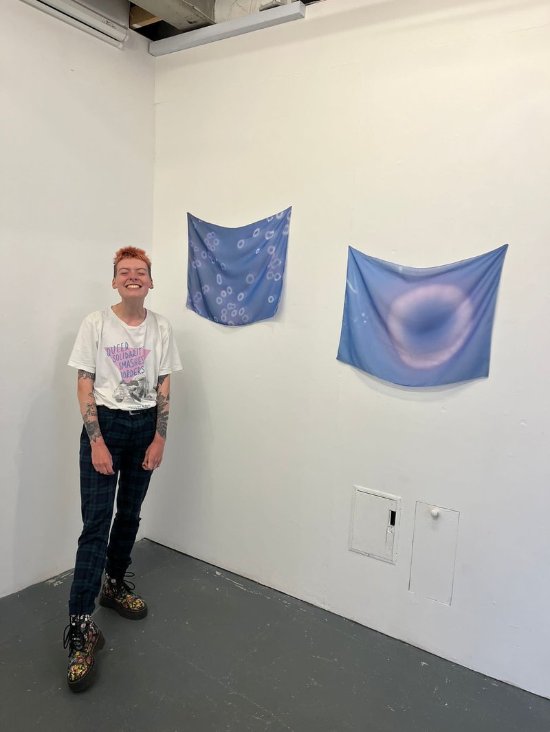 Hattie smiling in front of their work