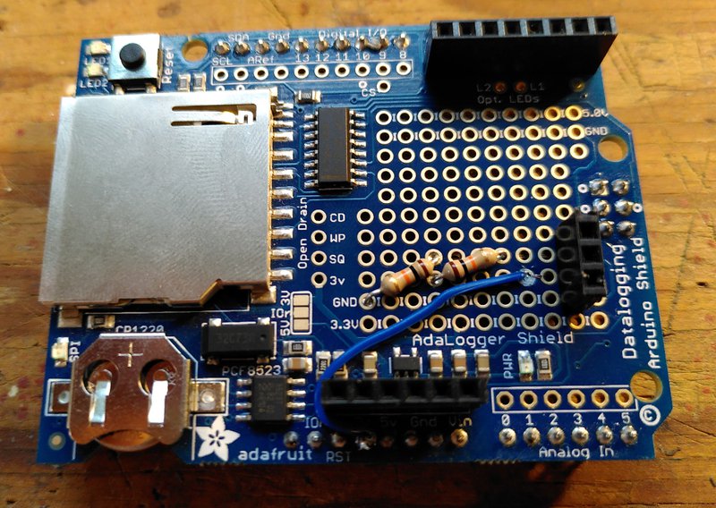 Adafruit data logger circuit board with some additional resistors and connectors soldered on to the perma-proto breakout area