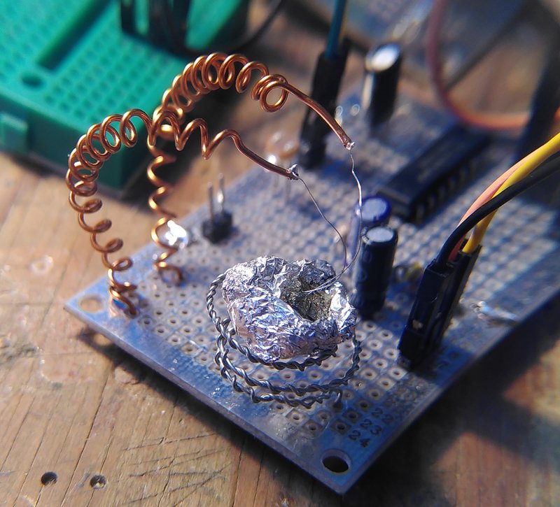 Mounting a crystal on a printed circuit board with coiled wires