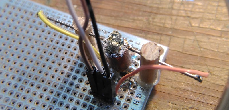Crystal held by a copper pipe soldered onto a printed circuit board